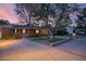Expansive driveway leads to a charming brick home with mature trees and well-maintained landscaping at 5818 N 3Rd Ave, Phoenix, AZ 85013
