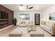 Bright living room features a modern fireplace, sleek furniture, and a unique accent wall at 6813 E Diamond St, Scottsdale, AZ 85257