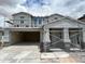 New construction home showcasing a modern exterior design and a spacious three-car garage at 7410 W Buckhorn Trl, Peoria, AZ 85383