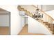 Bright entryway featuring wood floors, white walls, stairway with wood trim, and decorative chandelier at 8108 N Central Ave, Phoenix, AZ 85020