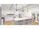 Beautiful kitchen featuring a spacious island, pendant lights, white cabinets, and stainless steel appliances at 8108 N Central Ave, Phoenix, AZ 85020