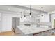 Beautiful kitchen featuring a spacious island, pendant lights, white cabinets, and stainless steel appliances at 8108 N Central Ave, Phoenix, AZ 85020