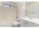 Bathroom with white vanity, mirror, and shower-tub combination at 8339 W Elm St, Phoenix, AZ 85037
