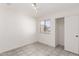 Bright bedroom with tile flooring, natural light from the window, and closet at 8339 W Elm St, Phoenix, AZ 85037