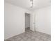Bright bedroom with tile flooring and adjoining door to another room at 8339 W Elm St, Phoenix, AZ 85037
