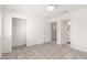 Bright bedroom with tile flooring, closet, and view to the bathroom at 8339 W Elm St, Phoenix, AZ 85037