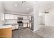 Well-equipped kitchen featuring stainless steel appliances, white cabinets, and wood-look tile flooring at 8339 W Elm St, Phoenix, AZ 85037