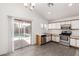Modern kitchen featuring white cabinets, stainless steel appliances, and a view of the backyard pool at 8339 W Elm St, Phoenix, AZ 85037