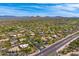 Expansive aerial view of a desert community featuring custom homes, a golf course, and stunning mountain views at 9780 E Gamble Ln, Scottsdale, AZ 85262