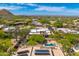 Stunning aerial view showcasing the home, pool, and mountain views in a lush desert community at 9780 E Gamble Ln, Scottsdale, AZ 85262