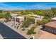 Beautiful aerial view of the home highlighting its desert landscaping, mature trees and architectural design at 9780 E Gamble Ln, Scottsdale, AZ 85262
