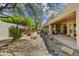 Lush backyard with a covered patio, rock drainage and mature landscaping at 9780 E Gamble Ln, Scottsdale, AZ 85262