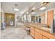 Bright bathroom with large mirrors, dual sinks, separate tub, and walk-in shower at 9780 E Gamble Ln, Scottsdale, AZ 85262