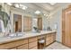 Bathroom with a large mirror, double sinks, stylish lighting, and plenty of counter space at 9780 E Gamble Ln, Scottsdale, AZ 85262