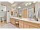 Bright bathroom with a skylight, large mirror, double sinks and a separate toilet room at 9780 E Gamble Ln, Scottsdale, AZ 85262