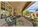 Lovely covered patio with comfortable chairs and scenic views of the lush garden at 9780 E Gamble Ln, Scottsdale, AZ 85262