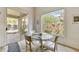 Cozy dining area with a glass table and backyard views at 9780 E Gamble Ln, Scottsdale, AZ 85262