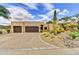 Attractive exterior elevation featuring a spacious driveway, desert landscaping, and two-car garage at 9780 E Gamble Ln, Scottsdale, AZ 85262