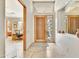 Inviting foyer with stone floors, wood door, and views of the office at 9780 E Gamble Ln, Scottsdale, AZ 85262