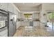 Modern kitchen featuring stainless steel appliances, granite countertops, custom cabinetry, and backyard views at 9780 E Gamble Ln, Scottsdale, AZ 85262