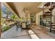 Inviting outdoor patio with a dining table, ceiling fans, and an access to a spiral staircase at 9780 E Gamble Ln, Scottsdale, AZ 85262