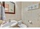 Stylish powder room featuring marble walls, a vessel sink, and modern fixtures at 9780 E Gamble Ln, Scottsdale, AZ 85262