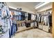 Spacious walk-in closet with ample hanging space, shelving, and a bright overhead light at 9780 E Gamble Ln, Scottsdale, AZ 85262