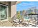 Balcony with seating overlooking a pool and neighboring apartment buildings at 1 E Lexington Ave # 302, Phoenix, AZ 85012
