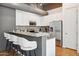 Kitchen with granite countertops, stainless steel appliances, and a breakfast bar with seating at 1 E Lexington Ave # 302, Phoenix, AZ 85012