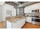 Kitchen featuring granite countertops, stainless steel appliances, and a breakfast bar at 1 E Lexington Ave # 302, Phoenix, AZ 85012