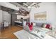Open concept living room with modern kitchen, exposed ductwork, and a cozy gray couch at 1 E Lexington Ave # 302, Phoenix, AZ 85012