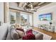 Bright living room with exposed ductwork, large windows, and a comfortable gray couch at 1 E Lexington Ave # 302, Phoenix, AZ 85012