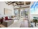 Bright living room featuring exposed ductwork, large windows, and a comfortable gray couch at 1 E Lexington Ave # 302, Phoenix, AZ 85012