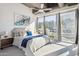 Bright main bedroom featuring large windows, a comfortable bed, and stylish décor at 1 E Lexington Ave # 302, Phoenix, AZ 85012