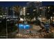 Nighttime view of the community pool and surrounding apartment buildings at 1 E Lexington Ave # 302, Phoenix, AZ 85012