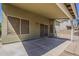 View of the backyard's covered patio that has sliding glass doors and screen windows at 1079 E Jasper Dr, Gilbert, AZ 85296