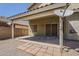 Backyard patio made with stone blocks leading from the house to a gravel area with a brick wall in the background at 1079 E Jasper Dr, Gilbert, AZ 85296