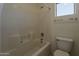 Standard bathroom features a shower over the tub, a toilet and a window above a towel rack at 1079 E Jasper Dr, Gilbert, AZ 85296