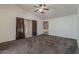 This bedroom features a ceiling fan, neutral paint, and plush carpeting at 1079 E Jasper Dr, Gilbert, AZ 85296
