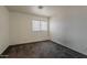 This carpeted bedroom has bright walls, one window with blinds, and electrical outlets around the room at 1079 E Jasper Dr, Gilbert, AZ 85296