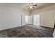This carpeted bedroom features neutral paint and access to the other rooms at 1079 E Jasper Dr, Gilbert, AZ 85296