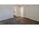 This carpeted bedroom shows entryways to two bathrooms and another room; the walls are bright and bare at 1079 E Jasper Dr, Gilbert, AZ 85296