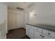 Hallway with carpet, a counter with cabinets, a light fixture, and two doors for storage at 1079 E Jasper Dr, Gilbert, AZ 85296