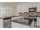 A modern kitchen featuring a spacious layout, granite countertops, and stainless steel appliances at 1079 E Jasper Dr, Gilbert, AZ 85296