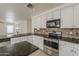 This kitchen features granite countertops, stainless steel appliances and ample counter space at 1079 E Jasper Dr, Gilbert, AZ 85296