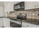 A close up of the kitchen with stainless steel appliances, granite countertops, and tile backsplash at 1079 E Jasper Dr, Gilbert, AZ 85296