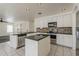 This kitchen features stainless steel appliances, granite countertops, white cabinets, and a center island at 1079 E Jasper Dr, Gilbert, AZ 85296
