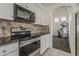 A modern kitchen design includes stainless steel appliances and black granite countertops at 1079 E Jasper Dr, Gilbert, AZ 85296