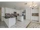 Well-lit kitchen featuring white cabinets, granite countertops, and stainless steel appliances, offering ample storage at 1079 E Jasper Dr, Gilbert, AZ 85296