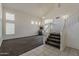 Inviting living room with staircase, featuring carpet flooring and natural light, showcasing a spacious design at 1079 E Jasper Dr, Gilbert, AZ 85296
